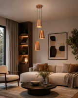 Hudson Cascading Cone Cluster Pendant Light installed in a contemporary living room above a seating area, adding warm ambient lighting and modern handcrafted style.