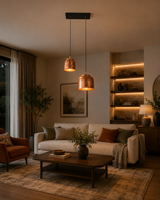 Lifestyle view of Hudson hammered copper dual pendant chandelier with handcrafted textured copper shades illuminating a modern living room.