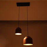 Night view of Hudson hammered copper dual pendant chandelier emitting warm ambient light from handcrafted hammered copper shades.
