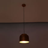 Hudson hammered dome pendant light with warm glowing interior highlighting handcrafted copper texture
