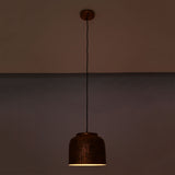 Hudson hammered copper dome pendant light at night emitting warm focused downward illumination