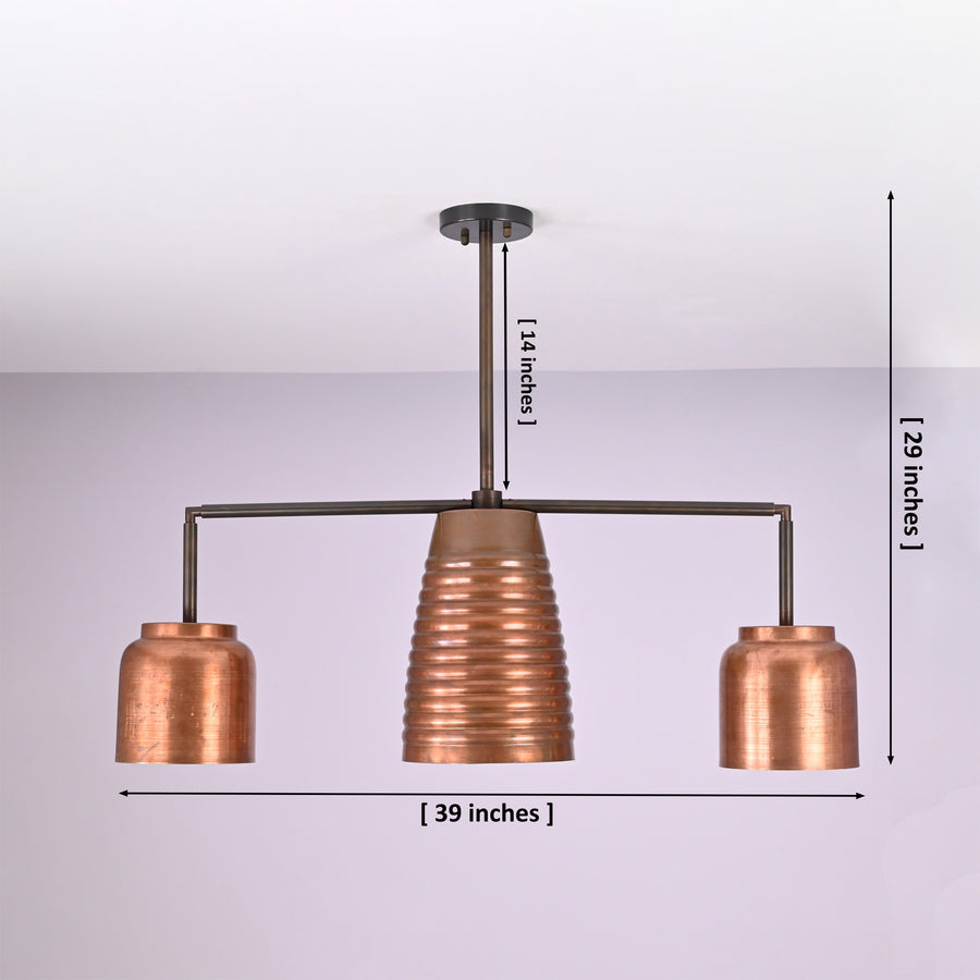Hudson Modern Linear Three Shade Chandelier illuminating a contemporary dining room with a ribbed center shade and two cylindrical side shades.