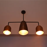 Hudson Modern Linear Three Shade Chandelier producing warm ambient illumination with three downward-facing metal shades.
