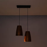 Hudson handcrafted copper dual cone pendant light illuminated with warm ambient lighting highlighting the textured metal finish.