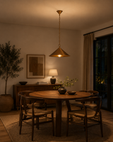 Hudson Mini Cone Pendant Light suspended above a round dining table in a warm modern dining room with soft ambient lighting and Scandinavian-inspired décor.