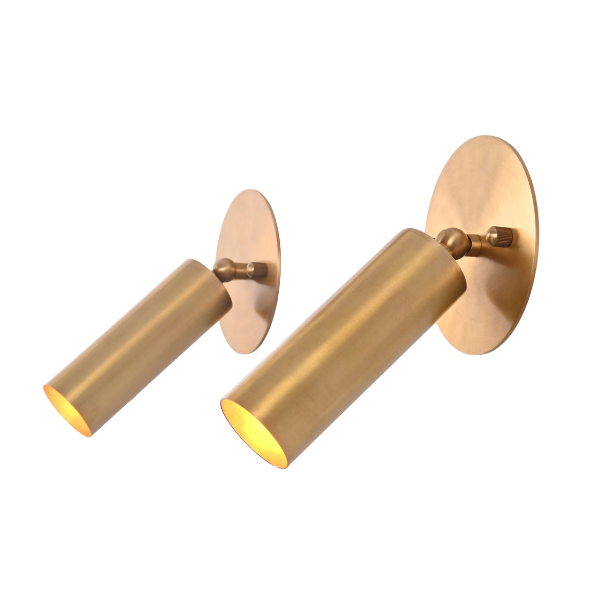 Angled view of the Hudson Modern Brass Adjustable Cylinder Wall Sconce highlighting the adjustable swivel head, handcrafted cylindrical shade, and warm directional illumination.