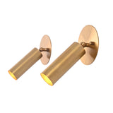 Angled view of the Hudson Modern Brass Adjustable Cylinder Wall Sconce highlighting the adjustable swivel head, handcrafted cylindrical shade, and warm directional illumination.