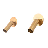 Perspective view of a pair of Hudson Modern Brass Adjustable Cylinder Wall Sconces featuring handcrafted cylindrical shades with swivel heads and round backplates for directional accent lighting.
