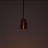 Close-up illuminated Hudson brushed copper bell pendant light highlighting handcrafted finish and soft glow