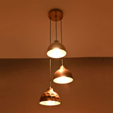Hudson modern copper three shade cluster pendant light illuminated with warm ambient lighting