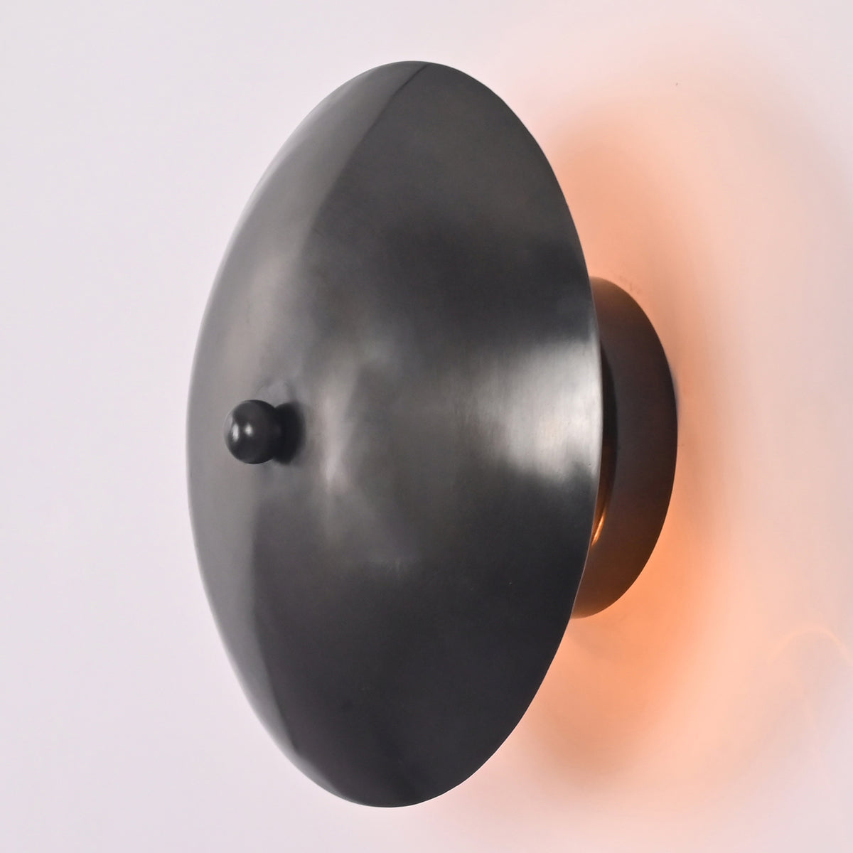 Angled view of the Hudson Modern Dome Wall Sconce highlighting its sculptural dome shade and minimalist wall-mounted design.