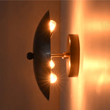 Illuminated side view of the Hudson Modern Dome Wall Sconce showing concealed bulbs creating soft indirect ambient lighting.