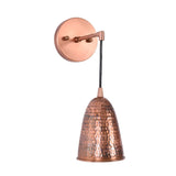 Three-quarter view of the Hudson Modern Hammered Copper Cone Wall Sconce featuring a textured hammered copper cone shade with a minimalist cantilever arm and circular wall canopy.