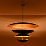 Side profile of the Hudson Modern Layered Disc Chandelier displaying stacked sculptural disc shades with warm concealed LED illumination.