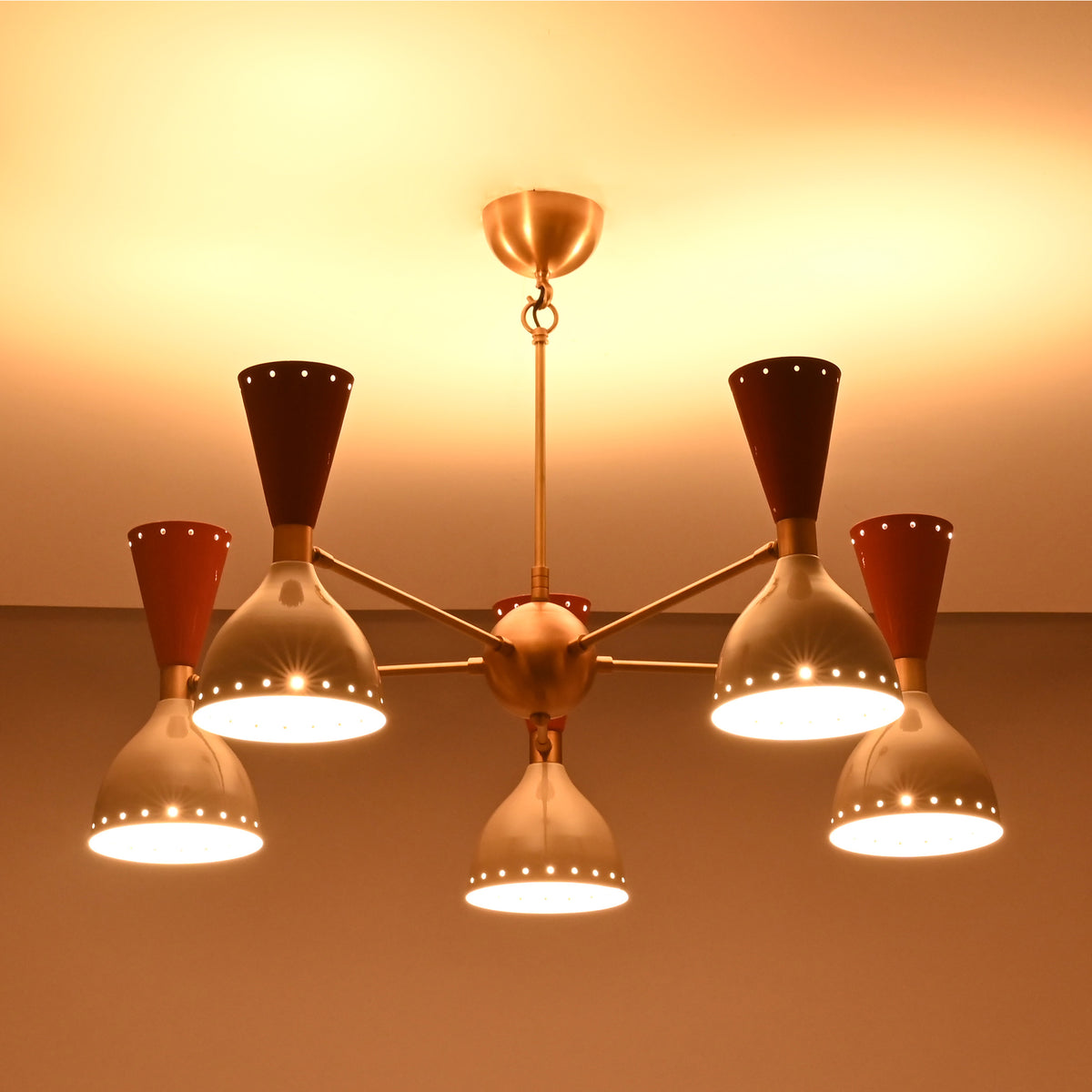 Close-up of Hudson Modern 5-light chandelier highlighting perforated cone shades and warm ambient illumination.