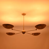 Ambient lighting view of the Hudson Modern Quad Bowl Chandelier creating soft upward illumination with adjustable bowl shades.