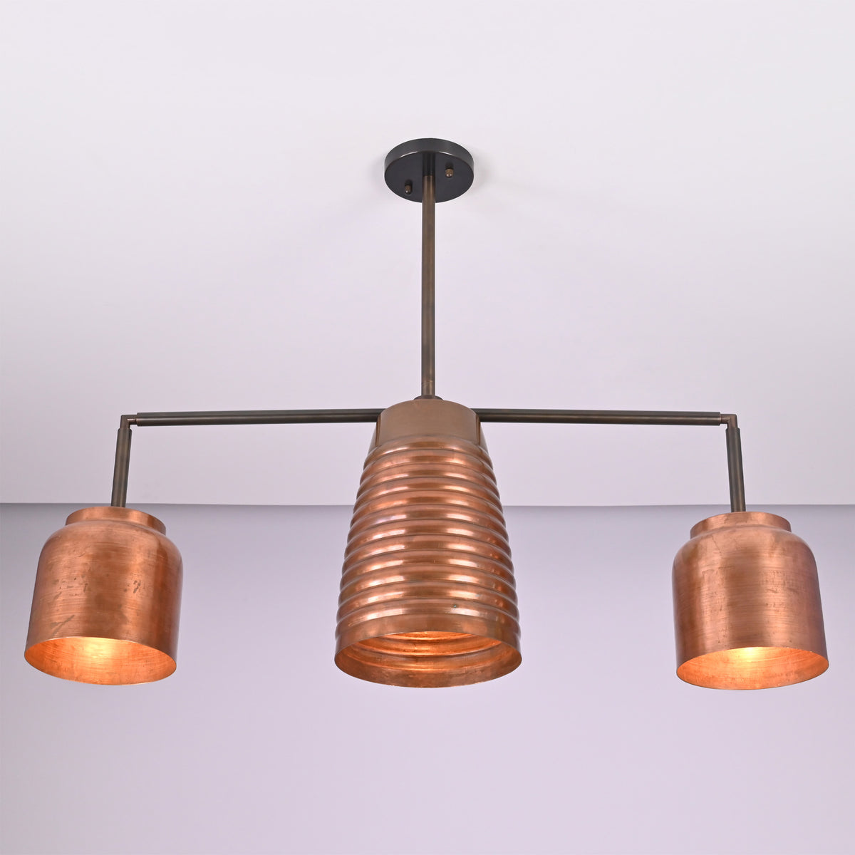 Hudson Modern Three Light Linear Chandelier with ribbed center shade and matching cylindrical side shades shown in a straight front view.