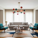Hudson 12 light Mid-Century Modern chandelier displayed from a ceiling perspective with colorful rounded shades and radiating brass-tone arms.