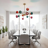 Hudson 12 light Mid-Century Modern Sputnik chandelier shown from the front with colorful rounded shades and brass-tone multi-arm construction.