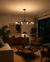 Hudson Orbit Sputnik 12-light chandelier installed in a modern living room, providing warm ambient illumination with a Mid-Century Modern starburst design.