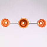 Bottom view of the Hudson Modern Linear Three Shade Chandelier displaying the illuminated interiors of the three handcrafted metal shades.