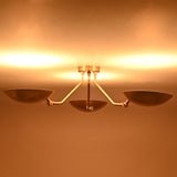 Illuminated front view of Hudson triple dish chandelier creating warm indirect ambient ceiling lighting.