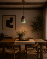 Hudson Verdigris Tapered Pendant Light installed above a rustic dining table, adding warm ambient lighting with its handcrafted verdigris patina and copper interior.