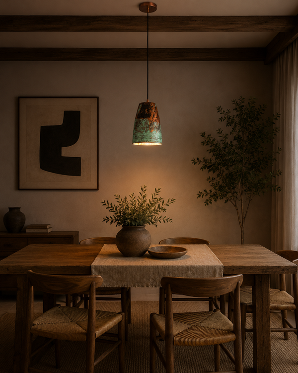 Hudson Verdigris Tapered Pendant Light installed above a rustic dining table, adding warm ambient lighting with its handcrafted verdigris patina and copper interior.
