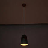 Warm illuminated view of the Hudson Verdigris Tapered Pendant Light featuring a handcrafted tapered shade with an aged verdigris finish and copper-lined interior