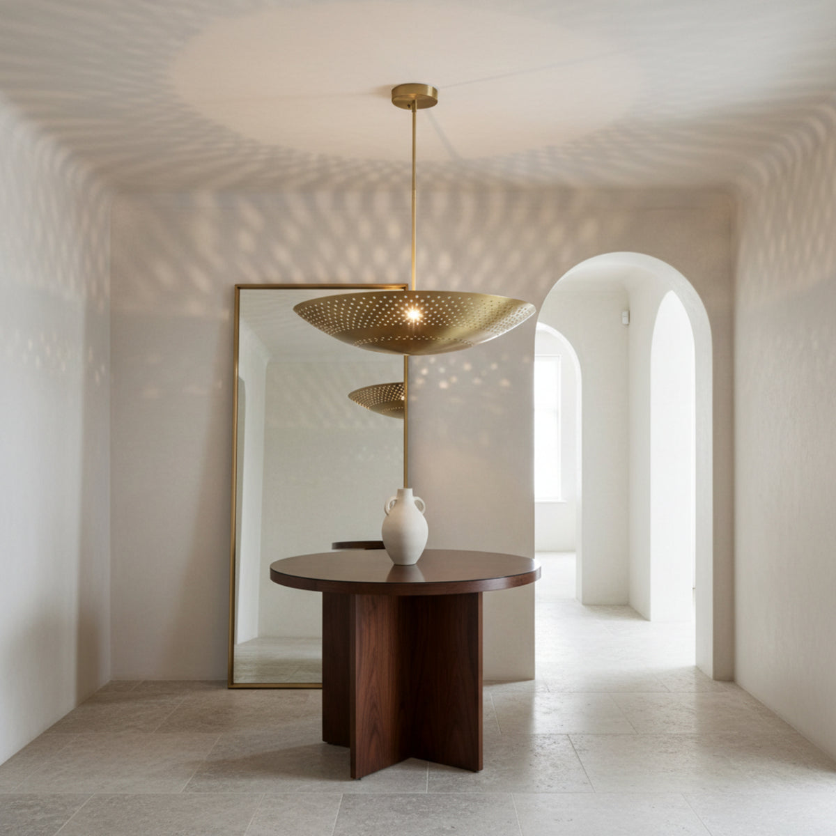 Ibiza 5 light perforated brass disc chandelier shown from an angled view with decorative precision-cut holes.