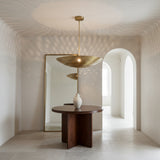 Ibiza 5 light perforated brass disc chandelier shown from an angled view with decorative precision-cut holes.