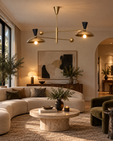 Ibiza 4 light brass-tone dome shade chandelier displayed in a contemporary living room with warm ambient lighting and modern furnishings.