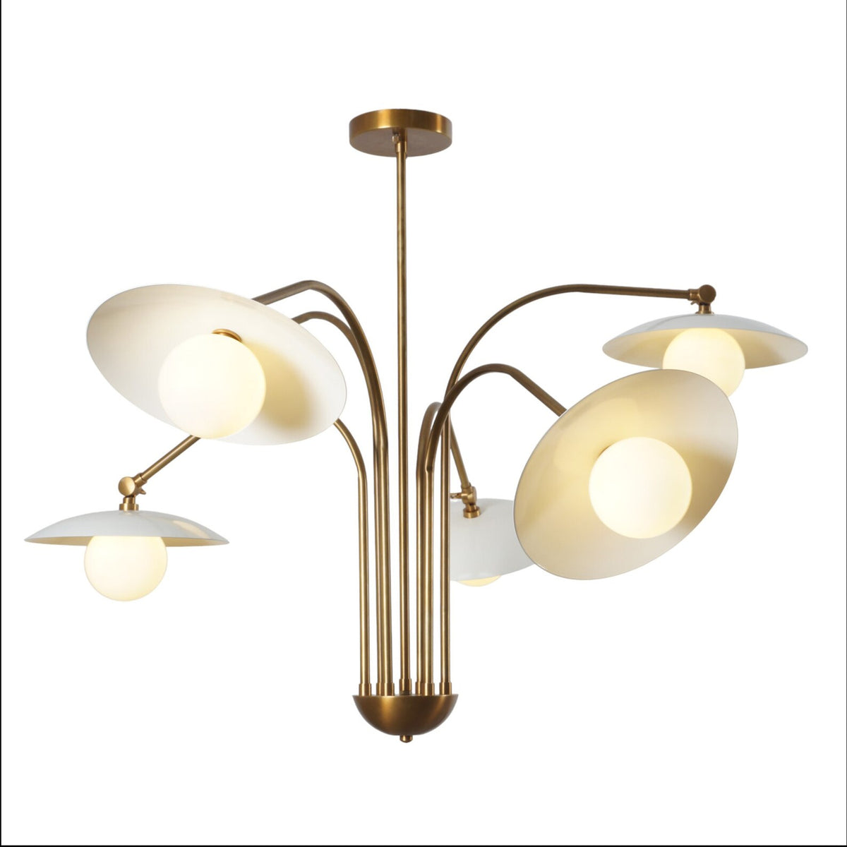 Mid-century modern brass chandelier featuring six curved arms with frosted glass globes and white dish shades, suspended from a central stem.