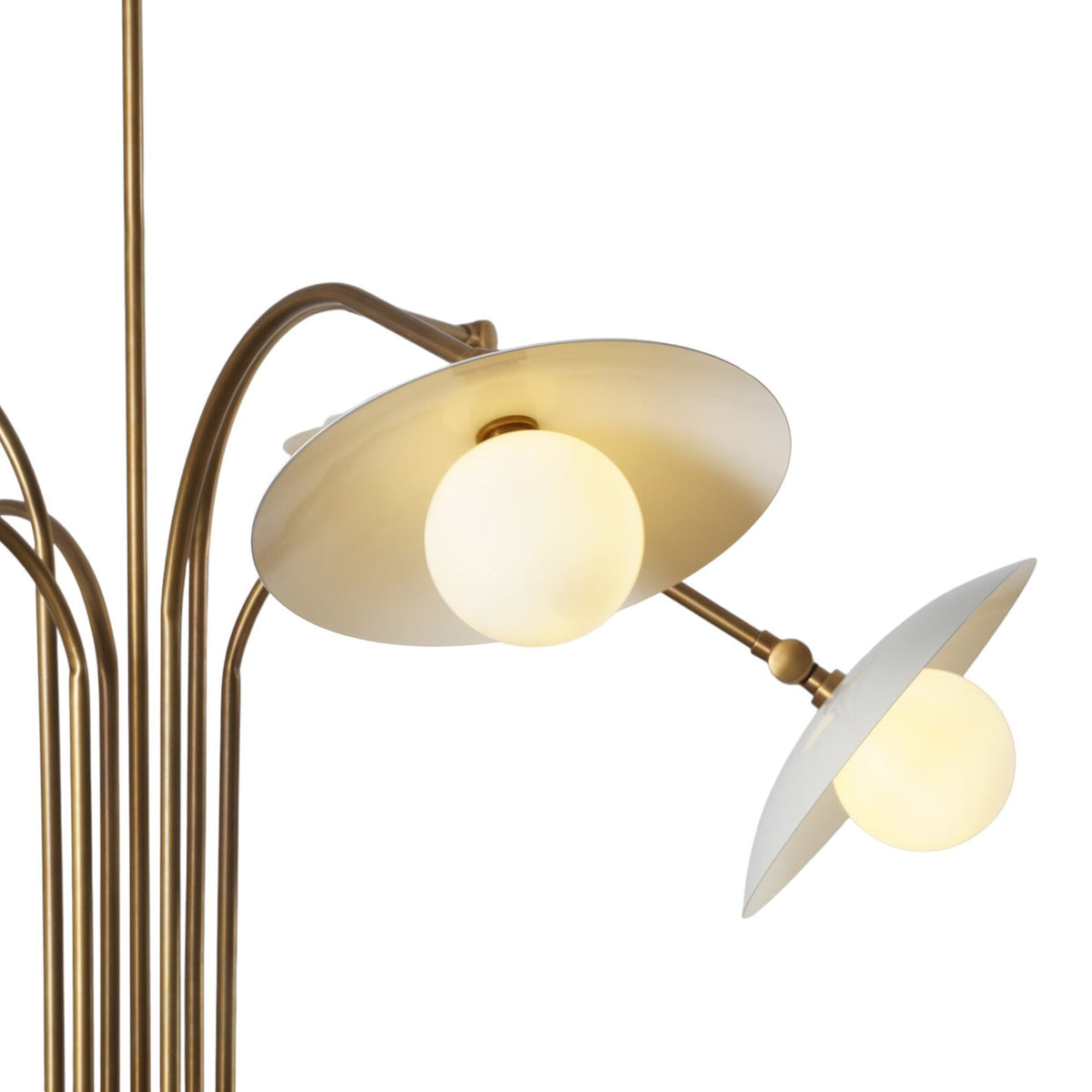 Close-up of a brass chandelier’s frosted glass shade and globe light, showcasing fine metal craftsmanship and warm illumination