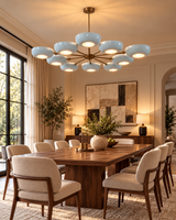 Lecce 10-light sky-blue bowl chandelier illuminating an elegant modern dining room with a large walnut dining table, cream upholstered chairs, and warm ambient lighting.