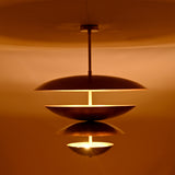 Lior Modern Tiered Disc Chandelier illuminated with warm ambient lighting and layered Scandinavian-inspired disc shades
