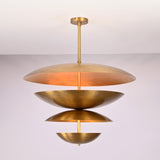 Front view of the Lior Modern Tiered Disc Chandelier featuring four layered brass-toned disc shades with warm ambient illumination