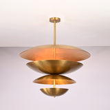 Illuminated front view of the Lior Modern Tiered Disc Chandelier showcasing soft glare-free light through layered metal discs