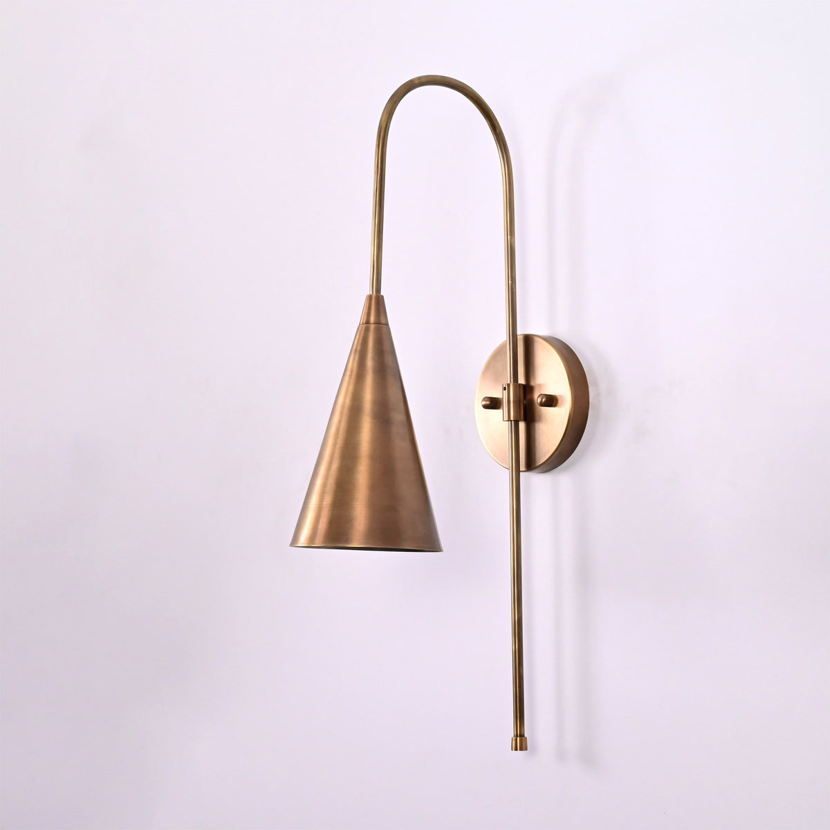 Liora Cone Loop Wall Sconce shown from the side with arched loop arm and tapered cone shade.