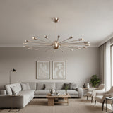 Lucca 18 light Mid-Century Modern Sputnik chandelier shown in a brass-tone finish with slender starburst arms and exposed bulbs.