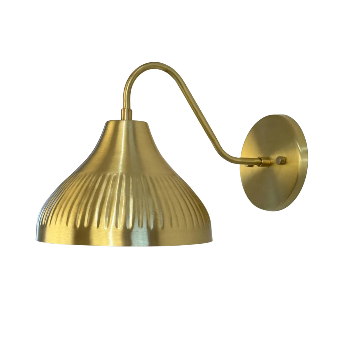 Side perspective of the Luna Fluted Dome Wall Sconce featuring a curved brass arm, handcrafted fluted dome shade, and circular wall backplate.
