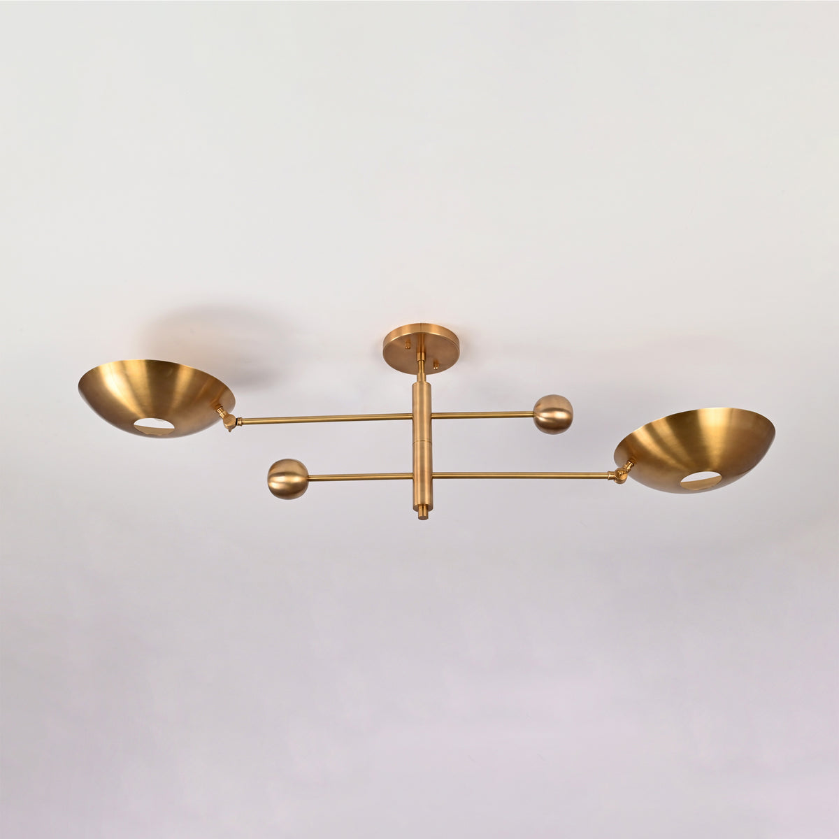 Angled front view of the Luna Modern Double Bowl Chandelier showcasing its minimalist linear silhouette and upward-facing bowl shades