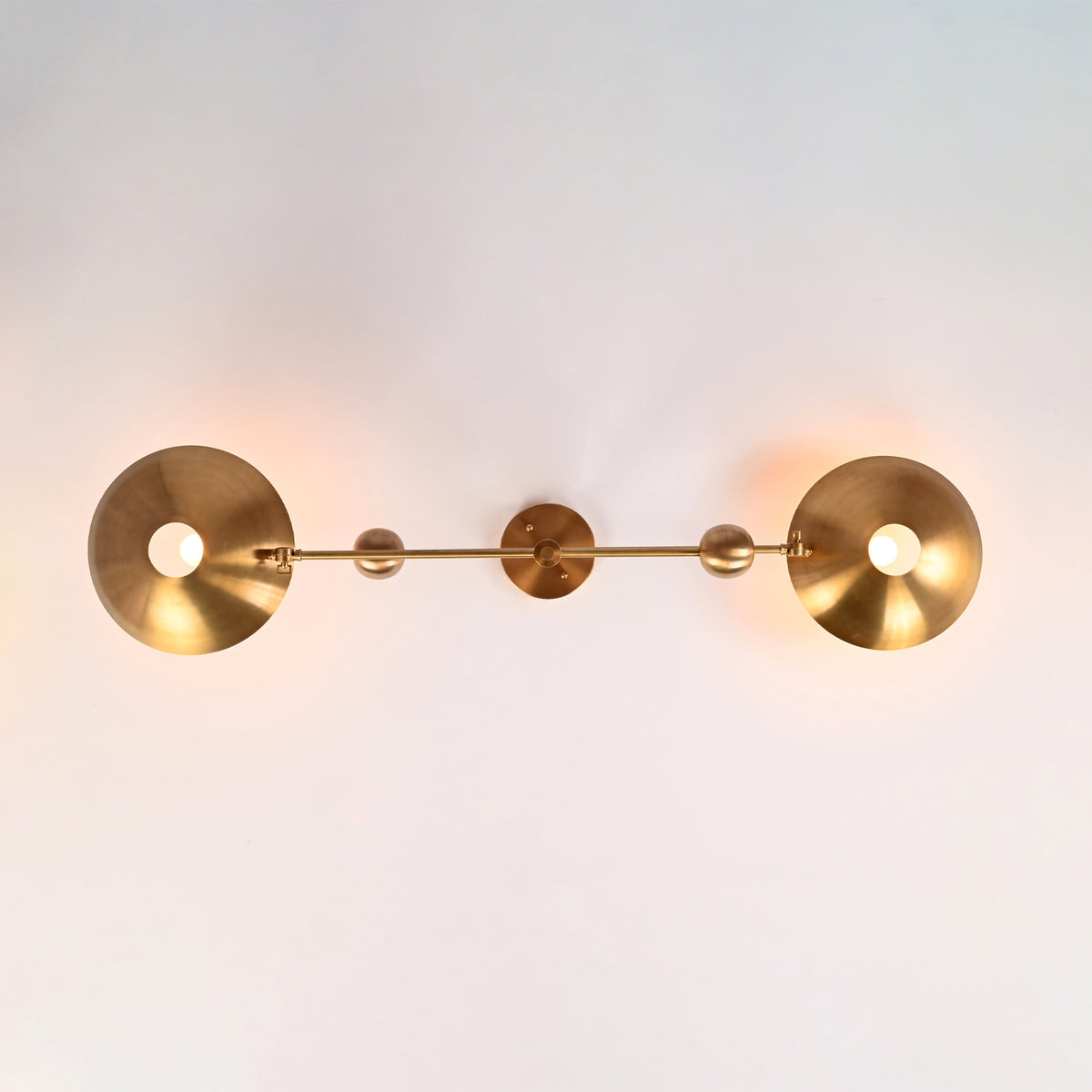 Bottom view of the Luna Modern Double Bowl Chandelier highlighting symmetrical bowl shades, spherical counterweights, and two-light design