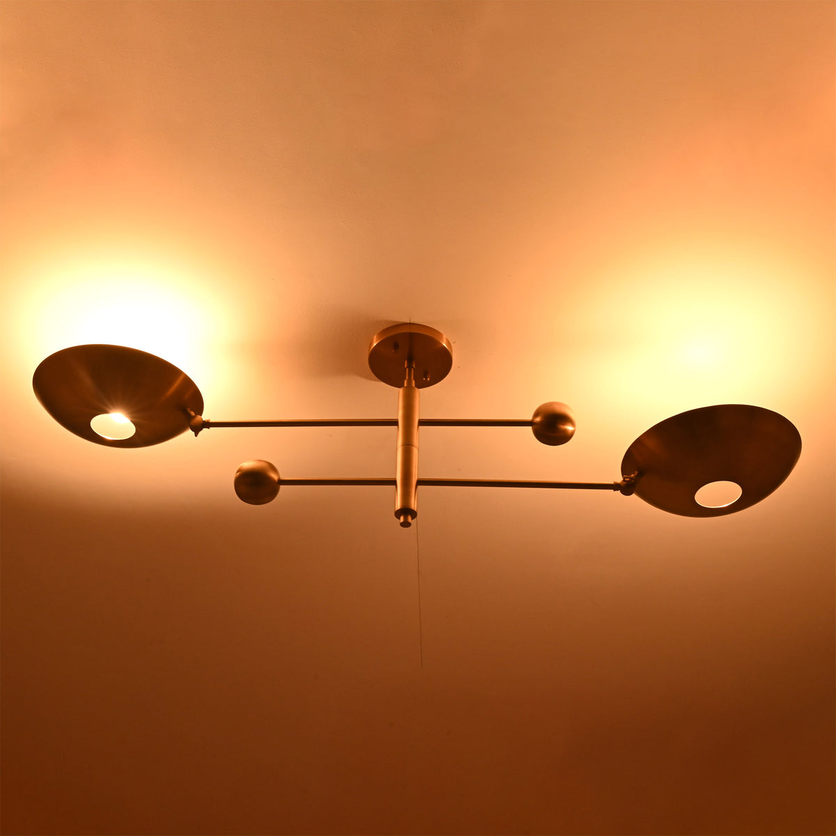 Night view of the Luna Modern Double Bowl Chandelier with soft upward ambient lighting and elegant architectural silhouette