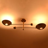 Night view of the Luna Modern Double Bowl Chandelier with soft upward ambient lighting and elegant architectural silhouette