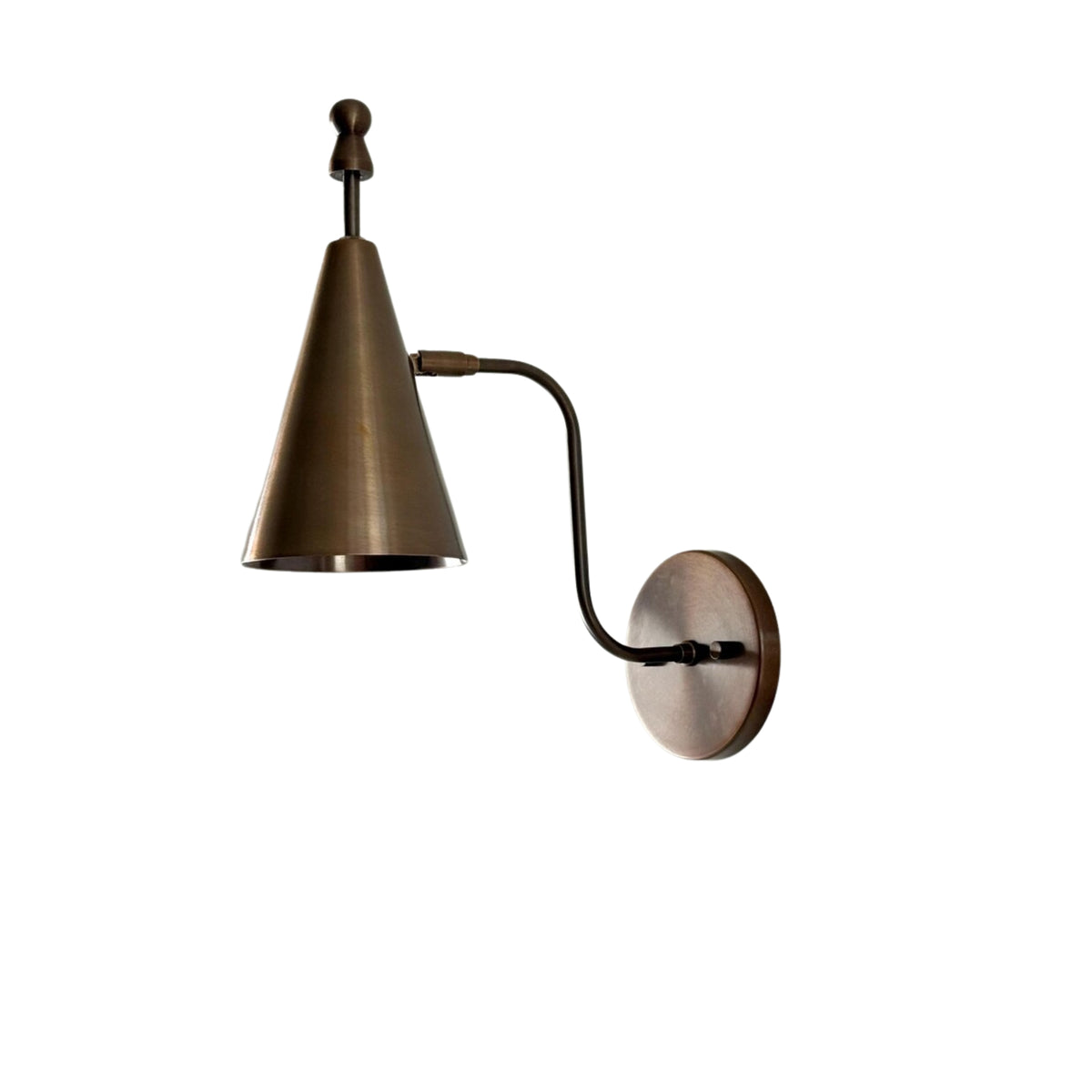 Angled front view of the Luna Modern Tapered Cone Wall Sconce showcasing the tapered cone shade, sculptural curved arm, decorative finial, and round wall canopy in an antique bronze finish.