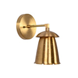 Side angled view of Luna bell wall sconce with perforated shade and warm decorative detailing.