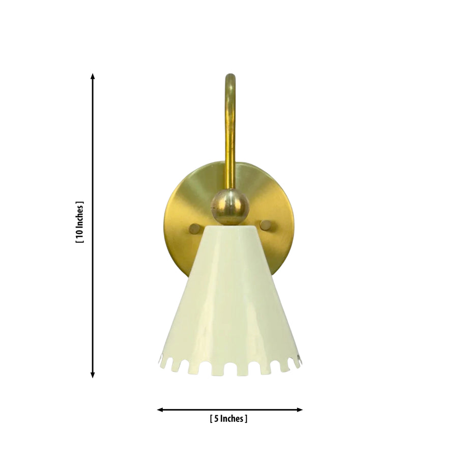 The Luna Scalloped Cone Wall Sconce installed beside a bed in a modern bedroom, providing warm ambient lighting with its white scalloped shade and solid brass finish.