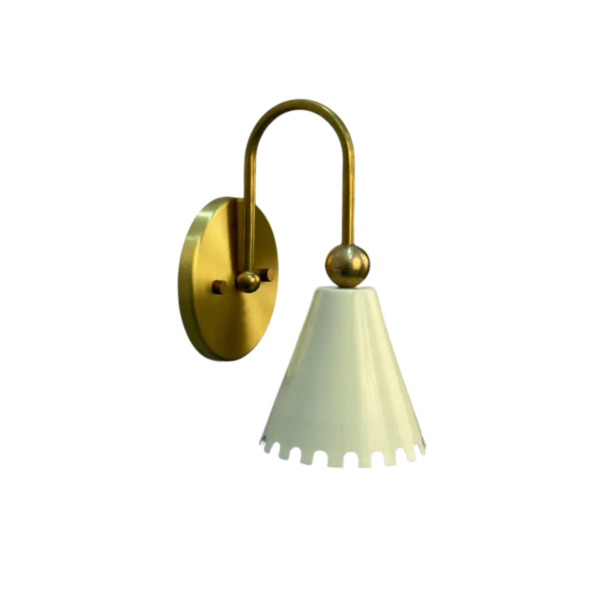 Front angled view of the Luna Scalloped Cone Wall Sconce featuring a handcrafted white scalloped metal shade, decorative brass sphere, curved solid brass arm, and round wall canopy.