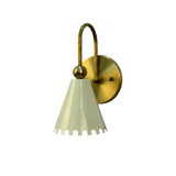 Rear perspective view of the Luna Scalloped Cone Wall Sconce emphasizing the handcrafted brass construction, curved support arm, and scalloped white metal shade.
